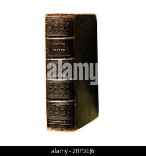 Old leather Book of Common Prayer against white background. Studio set up. Stock Photo
