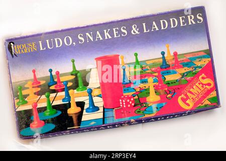 Old box of games - Ludo, Snakes & Ladders. Studio set up Stock Photo
