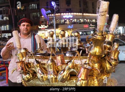 (181013) -- BAGHDAD, Oct. 13, 2018 -- A street vendor sells tea in Al-Mansour district, Baghdad, Iraq, Oct. 13, 2018. Nightlife has thrived in some districts of Baghdad with the significant improvement of security situation after Iraqi security forces fully defeated the extremist Islamic State militants across the country late in 2017. ) IRAQ-BAGHDAD-NIGHTLIFE KhalilxDawood PUBLICATIONxNOTxINxCHN Stock Photo