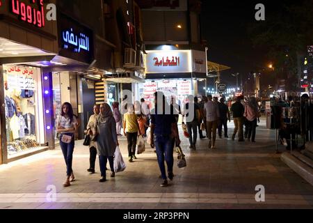 (181013) -- BAGHDAD, Oct. 13, 2018 -- Local residents go shopping in Al-Mansour district, Baghdad, Iraq, Oct. 13, 2018. Nightlife has thrived in some districts of Baghdad with the significant improvement of security situation after Iraqi security forces fully defeated the extremist Islamic State militants across the country late in 2017. ) IRAQ-BAGHDAD-NIGHTLIFE KhalilxDawood PUBLICATIONxNOTxINxCHN Stock Photo