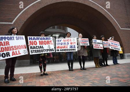 (181016) -- BOSTON, Oct. 16, 2018 -- Demonstrators hold slogans in front of John Joseph Moakley United States Courthouse in Boston, Massachusetts, the United States, on Oct. 15, 2018. A lawsuit charging Harvard University of discriminating against Asian American applicants in admissions went to trial on Monday at a U.S. District Court in Boston, drawing nationwide attention as the future of the affirmative action is also on the debate. TO GO WITH Spotlight: Trial starts over racial discrimination charges against Harvard in admissions. ) (zhf) U.S.-BOSTON-HARVARD UNIVERSITY-RACIAL DISCRIMINATIO Stock Photo