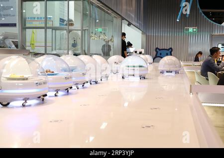 (181020) -- SHANGHAI, Oct. 20, 2018 -- AGV (automated guided vehicle) robots line up to serve food to customers in a smart restaurant operated by Chinese e-commerce giant Alibaba at the National Exhibition and Convention Center in east China s Shanghai, Oct. 15, 2018. ) (lmm) CHINA-SHANGHAI-ROBOT-RESTAURANT (CN) FangxZhe PUBLICATIONxNOTxINxCHN Stock Photo