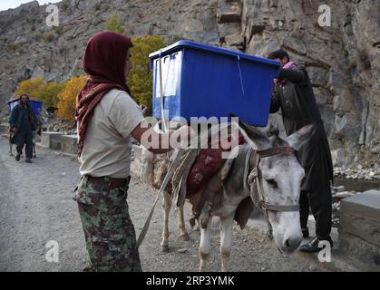 (181019) -- PANJSHIR (AFGHANISTAN), Oct. 19, 2018 -- Workers of Afghan Independent Election Commission (IEC) transport election materials in Abdullah Khil valley of Dara district of Panjshir province, eastern Afghanistan, on Oct. 19, 2018. Afghanistan will hold elections for Wolesi Jirga or the lower house of the parliament on Saturday amid serious security challenges. ) AFGHANISTAN-PANJSHIR-ELECTION MATERIALS RahmatxAlizadah PUBLICATIONxNOTxINxCHN Stock Photo