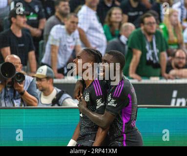 sports, football, Bundesliga, 2023/2024, Borussia Moenchengladbach vs. FC Bayern Munich 1-2, Stadium Borussia Park, rejoicing at the 1-2 winning goal, goal scorer Mathys Henri Tel (FCB) left and Dayotchanculle Oswald Upamecano (FCB), Marvin Friedrich (MG), DFL REGULATIONS PROHIBIT ANY USE OF PHOTOGRAPHS AS IMAGE SEQUENCES AND/OR QUASI-VIDEO Stock Photo