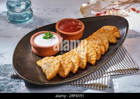 Traditional Turkish food and Ravioli, Manti, on a beautiful background and plate. Stock Photo