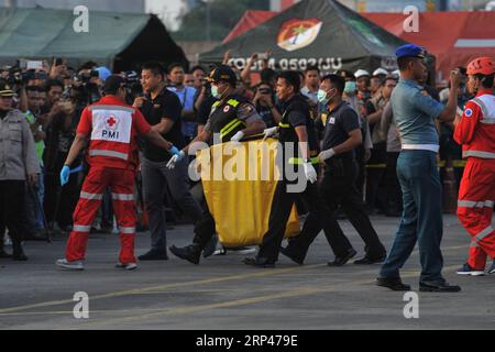 (181029) -- JAKARTA, Oct. 29, 2018 -- Search and Rescue officers move the body bags containing victims of the Lion Air JT610 that crashed into the sea off Karawang of West Java province at the joint base of Search and Rescue at the Tanjung Priok Port, Jakarta, Oct. 29, 2018. Indonesia s national Search and Rescue Agency said on Monday that all the 189 people onboard a Lion Air plane that crashed into the sea off western Indonesia may have died. ) (lrz) INDONESIA-JAKARTA-LION AIR-CRASH VerixSanovri PUBLICATIONxNOTxINxCHN Stock Photo