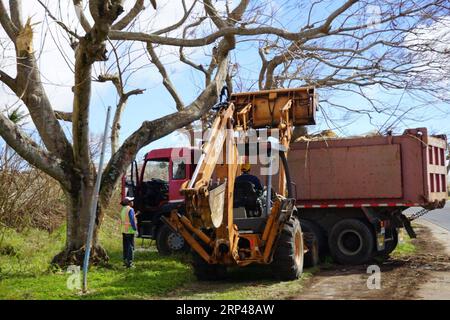 (181030) -- SAIPAN, Oct. 30, 2018 -- Workers clean the road outside Saipan International Airport, the Commonwealth of the Northern Mariana Islands (CNMI), Oct. 30, 2018. Super Typhoon Yutu, which hit the island territories overnight last Wednesday, caused extensive damage to critical infrastructure on Saipan and Tinian islands, including the Saipan airport. ) (djj) NORTHERN MARIANA ISLANDS-SAIPAN-TYPHOON GaoxShan PUBLICATIONxNOTxINxCHN Stock Photo