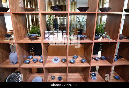 (181031) -- JIANYANG, Oct. 31, 2018 -- Photo taken on Oct. 29, 2018 shows products of Jian Zhan , a kind of black glaze bowl, at an exhibition hall in Jianyang, southeast China s Fujiang Province. Jian Zhan , a kind of temmoku glaze or black glaze porcelain, was then used only by emperors of ancient China s Song Dynasty (960-1279). Famous for its nobility and gorgeousness, Jian Zhan was numerously exported overseas through the Silk Road on the sea. However, after Song Dynasty, those traditional firing techniques to make Jian Zhan failed to be handed down to future generations. In recent years, Stock Photo