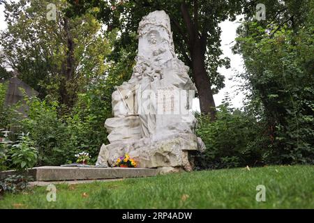 The grave of Johann Strauss, located in Vienna's Central Cemetery, is a touching homage to the 'Waltz King.' Adorned with a life-like statue and intri Stock Photo