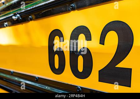 Side of a parked yellow school bus number 662 Stock Photo