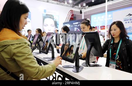(181109) -- SHANGHAI, Nov. 9, 2018 -- Visitors experience virtual makeup mirror at the Apparel, Accessories & Consumer Goods area at the first China International Import Expo (CIIE) in Shanghai, east China, Nov. 8, 2018. )(ly) (IMPORT EXPO)CHINA-SHANGHAI-CIIE (CN) FangxZhe PUBLICATIONxNOTxINxCHN Stock Photo