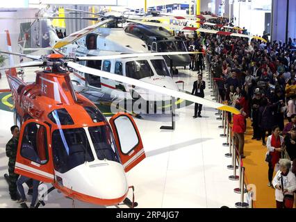 (181110) -- SHANGHAI, Nov. 10, 2018 -- Visitors view helicopters at the first China International Import Expo (CIIE) in Shanghai, east China, Nov. 10, 2018. The CIIE concluded here on Saturday. )(zyd) (IMPORT EXPO)CHINA-SHANGHAI-CIIE-CONCLUSION (CN) ChenxFei PUBLICATIONxNOTxINxCHN Stock Photo