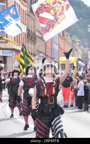 Aue Bad Schlema, Germany. 03rd Sep, 2023. Flag-wavers stride through the city center during the Saxon Day parade. Saxony's largest folk and local festival traditionally takes place on the first weekend in September. Credit: Sebastian Willnow/dpa/Alamy Live News Stock Photo