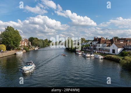 Staines-upon-Thames, Surrey, England, UK - view of the River Thames from Staines bridge on a sunny summer day with boats and people at the Swan Hotel Stock Photo