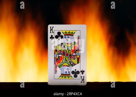 Fiery club king playing card with the fire in the background Stock Photo