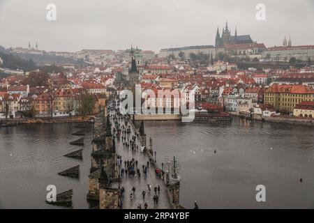 (181121) -- PRAGUE, Nov. 21, 2018 -- Tourists walk on the Charles Bridge in Prague, capital of Czech Republic, Nov. 20, 2018. A historical city, the Czech capital is decorated with many medieval monuments. Along the Voltava River, the Old Town, the Lesser Town and the New Town were built between the 11th and 18th centuries. The Historic Centre of Prague was included in the UNESCO World Heritage List in 1992. ) (clq) CZECH REPUBLIC-PRAGUE-SCENERY ZhengxHuansong PUBLICATIONxNOTxINxCHN Stock Photo