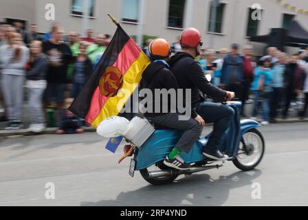 Aue Bad Schlema, Germany. 03rd Sep, 2023. Participants of the parade at the Day of Saxony with GDR flag on a moped of the brand 'Schwalbe'. Saxony's largest folk and local festival traditionally takes place on the first weekend in September. Credit: Sebastian Willnow/dpa/Alamy Live News Stock Photo