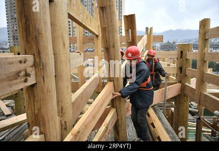 (181121) -- ENSHI, Nov. 21, 2018 -- Carpenters build stilt houses with traditional skills by the Gongshui River in the center of Xuan en County, central China s Hubei Province, Nov. 21, 2018. A total of five stilt houses were built in the county to display local culture of Tujia ethnic group for tourists. The construction technique of stilt houses of the Tujia ethnic group was listed as the national intangible cultural heritage in 2011. ) (ry) CHINA-HUBEI-XUAN EN-STILT HOUSE (CN) SongxWen PUBLICATIONxNOTxINxCHN Stock Photo
