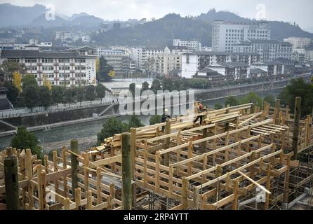 (181121) -- ENSHI, Nov. 21, 2018 -- Carpenters build stilt houses with traditional skills by the Gongshui River in the center of Xuan en County, central China s Hubei Province, Nov. 21, 2018. A total of five stilt houses were built in the county to display local culture of Tujia ethnic group for tourists. The construction technique of stilt houses of the Tujia ethnic group was listed as the national intangible cultural heritage in 2011. ) (ry) CHINA-HUBEI-XUAN EN-STILT HOUSE (CN) SongxWen PUBLICATIONxNOTxINxCHN Stock Photo
