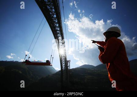 (181210) -- KUNMING, Dec. 10, 2018 () -- Photo taken on Dec. 9, 2018 shows the construction site of a railway arch bridge across the Nujiang River in southwest China s Yunnan Province. With a grand arch bridge erected on Monday morning, Chinese constructors have built the longest-spanning railway arch bridge with a single span of 490 meters. The bridge is a key project of the 220-km-long Dali-Ruili railway which is a key section of the China-Myanmar international railway corridor linking Kunming, the provincial capital of Yunnan, with Yangon of Myanmar. () (ly) CHINA-YUNNAN-NUJIANG RIVER-RAILW Stock Photo