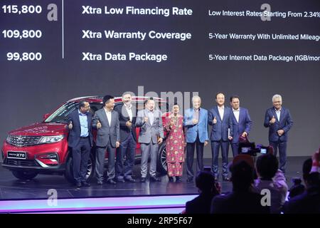 (181212) -- KUALA LUMPUR, Dec. 12, 2018 -- Malaysian Prime Minister Mahathir Mohamad (4th R) and his wife Siti Hasmah Mohamad Ali (5th R) pose for photos with guests and Proton officials during the official launching ceremony of Proton s SUV X70 in Kuala Lumpur, Malaysia, Dec. 12, 2018. Malaysian national car manufacturer Proton and China s Geely have unveiled their first joint commercial product on Wednesday with the launch of the X70 sports utility vehicle (SUV). ) MALAYSIA-KUALA LUMPUR-PROTON-X70-LAUNCHING ZhuxWei PUBLICATIONxNOTxINxCHN Stock Photo