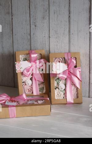 Homemade marshmallows in a paper gift boxes. Zephyr flowers. The boxes is tied with a ribbon tied into a bow. Stock Photo