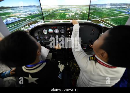 (181215) -- HARBIN, Dec. 15, 2018 -- Two boys try out a flight simulator cockpit at Wright Brothers Science and Technology Development Co., Ltd. in Harbin, northeast China s Heilongjiang Province, Nov. 24, 2018. If it were not for a common infatuation with flight simulation, chances are that Liu Zhongliang, Fu Qiang and Zhou Zhiyuan, who had once led three entirely distinct careers, might never come across one another, let alone team up and approach an aviation dream. The aviation enthusiast trio launched their hardware developing team in 2009. From the very first electronic circuit, to today Stock Photo