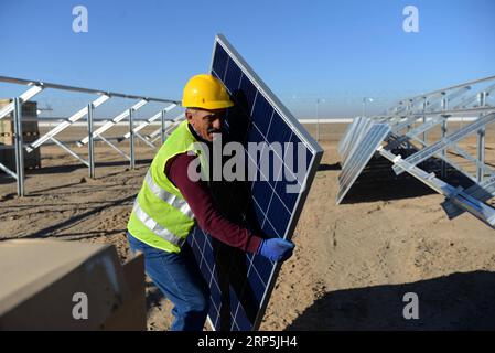 (181216) -- KANDAHAR, Dec. 16, 2018 -- A worker carries a solar panel at the site of a solar power plant project in Daman district of Kandahar province in southern Afghanistan, Dec. 16, 2018. ) AFGHANISTAN-KANDAHAR-SOLAR POWER PLANT-CONSTRUCTION SanaullahxSeiam PUBLICATIONxNOTxINxCHN Stock Photo
