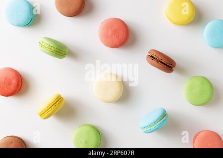 Sweet colorful French macaron biscuits  with different fillings on white background. Stock Photo