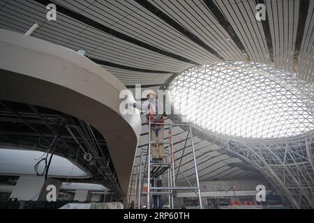(181229) -- BEIJING, Dec. 29, 2018 -- Staff members work in the Beijing Daxing International Airport under construction in Beijing, capital of China, on Dec. 29, 2018. The new airport s facade decoration project was completed on Friday. The airport is scheduled to start test operation by September next year.) CHINA-BEIJING-NEW AIRPORT-FACADE(CN) JuxHuanzong PUBLICATIONxNOTxINxCHN Stock Photo