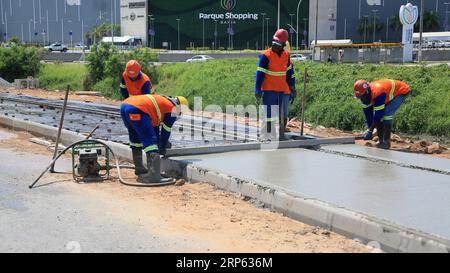 lauro de freitas, bahia, brazil - august 30, 2023: Construction workers are seen making concrete pavement on a sidewalk. Stock Photo