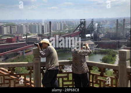 (190106) -- BEIJING, Jan. 6, 2019 (Xinhua) -- Xinhua Headlines:Steel City Still Vibrant with Olympic Rings Retired worker of Shougang Hu Yulan (R) and a photographer take pictures of the to-be-closed steel factory of Shougang Group in Beijing, capital of China, May 30, 2010. (Xinhua/Li Wenming) Xinhua Headlines:Steel City Still Vibrant with Olympic Rings PUBLICATIONxNOTxINxCHN Stock Photo