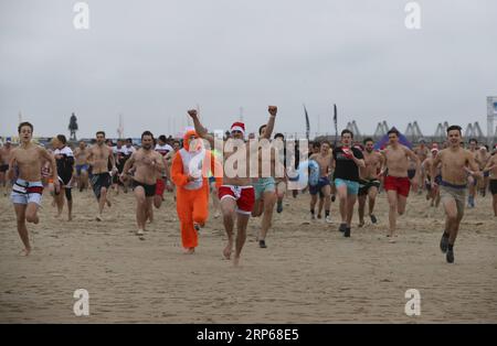 (190105) -- OSTEND (BELGIUM), Jan. 5, 2019 -- Crowds of people run into the sea to take part in the New Year s Dive in Ostend, Belgium, Jan. 5, 2018. The event is a traditional celebration in the city of Ostend. People believe that a refreshing dive into the North Sea is an ideal way to freeze the hangover from the holidays and to enter a new healthy year. ) BELGIUM-OSTEND-NEW YEAR S DIVE YexPingfan PUBLICATIONxNOTxINxCHN Stock Photo