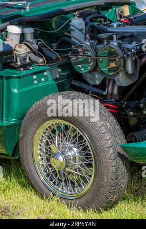 close-up of vintage or collectors car engine and wire spoked wheel Stock Photo