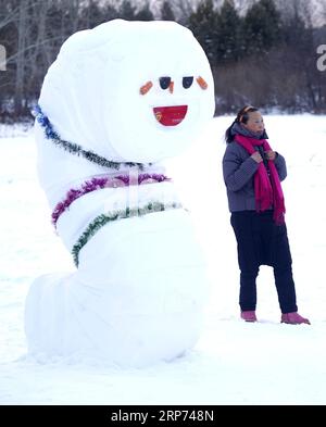 (190127) -- MOHE, Jan. 27, 2019 (Xinhua) -- A tourist poses for photos with a snow sculpture in China s northernmost Beiji Village of Mohe, northeast China s Heilongjiang Province, Jan. 24, 2019. Mohe greets the peak tourism season as winter comes. (Xinhua/Cai Yang) CHINA-HEILONGJIANG-MOHE-SCENERY (CN) PUBLICATIONxNOTxINxCHN Stock Photo