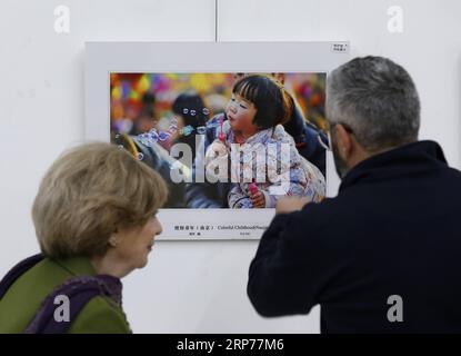 (190130) -- BEIRUT, Jan. 30, 2019 -- Visitors look at a photo during a photo exhibition commemorating the 40th anniversary of China s reform and opening-up in Beirut, Lebanon, on Jan. 30, 2019. The photo exhibition on the 40th anniversary of China s reform and opening-up, jointly held by Chinese Embassy in Lebanon and the Lebanese Academy of Fine Arts, opened here on Wednesday and will last till Feb. 2. ) LEBANON-BEIRUT-PHOTO EXHIBITION-CHINA-REFORM AND OPENING-UP BilalxJawich PUBLICATIONxNOTxINxCHN Stock Photo