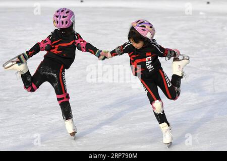 (190201) -- BEIJING, Feb. 1, 2019 (Xinhua) -- Photo taken on Jan. 9, 2019 shows students practicing during a training session at Taipingzhuang Central Primary School, in Yanqing District of Beijing, capital of China. Taipingzhuang Central Primary School situated right at the foot of Xiaohaituo Mountains, where the venues for Beijing 2022 Winter Olympic games are under construction. Teachers of Taipingzhuang Central Primary School have turned an experimental farmland into a seasonal skating rink for the pupils here to learn skating since 2016. The school hired a experienced coach, Li Chunyu, to Stock Photo