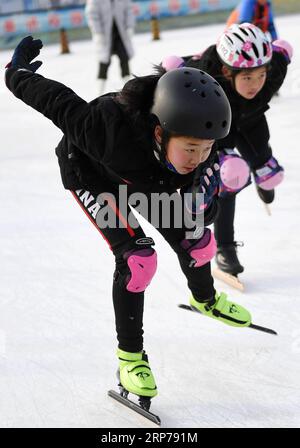 (190201) -- BEIJING, Feb. 1, 2019 (Xinhua) -- Photo taken on Jan. 9, 2019 shows Wang Aoyun (front) and her friends practicing during a training session at Taipingzhuang Central Primary School, in Yanqing District of Beijing, capital of China. Taipingzhuang Central Primary School situated right at the foot of Xiaohaituo Mountains, where the venues for Beijing 2022 Winter Olympic games are under construction. Teachers of Taipingzhuang Central Primary School have turned an experimental farmland into a seasonal skating rink for the pupils here to learn skating since 2016. The school hired a experi Stock Photo