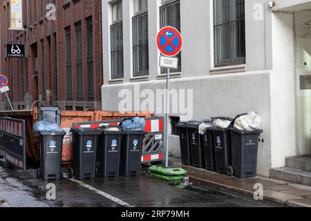 Symbolic image, city cleaning, waste disposal, recycling, bins for residual waste filled with rubbish bags at the roadside in Hamburg, Germany Stock Photo