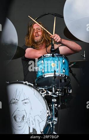 Razorlight drummer Andy Burrows performing with guitar on stage with ...