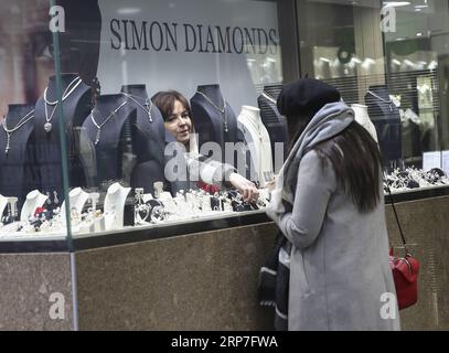 (190206) -- BEIJING, Feb. 6, 2019 -- Photo taken on Feb. 1, 2019 shows a jewelry store staff member picking up a piece of jewelry behind the window for a customer in downtown Antwerp, Belgium. ) Xinhua Headlines: Made-in-China diamonds poised to shape global market YexPingfan PUBLICATIONxNOTxINxCHN Stock Photo