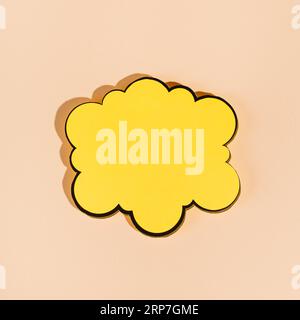 Empty yellow speech bubble beige background Stock Photo