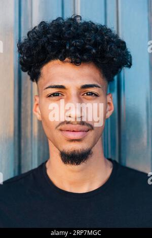 Confident ethnic man with curly hair Stock Photo
