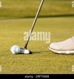 Man using club hit golf ball Stock Photo