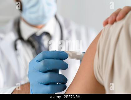 Man putting bandage young woman s arm Stock Photo