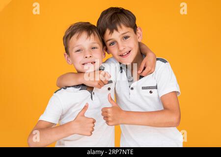 little brothers holding each other Stock Photo - Alamy