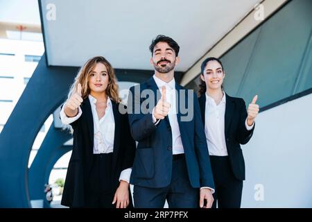 Team architects making thumbs up gesture Stock Photo