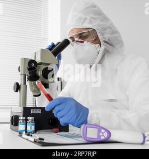 Doctor using microscope check covid sample Stock Photo