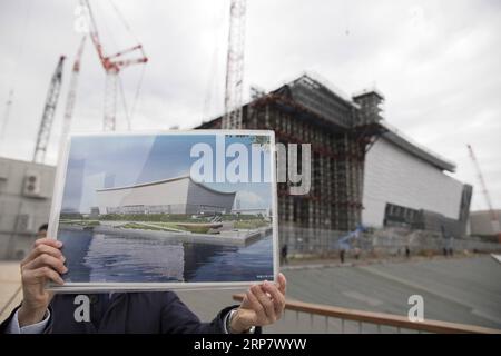 (190213) -- BEIJING, Feb. 13, 2019 (Xinhua) -- A staff member shows a design sketch of Ariake Arena, one of the Tokyo 2020 Olympic Games venues, at Ariake Arena construction site in Tokyo, Japan, Feb. 12, 2019. This venue for volleyball games has been finished 51 percent of the construction work till the end of last month. (Xinhua/Du Xiaoyi) XINHUA PHOTOS OF THE DAY PUBLICATIONxNOTxINxCHN Stock Photo