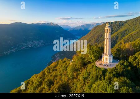 Aerial view of the Faro Voltiano of Brunate overlooking Como and Como Lake in summer at sunset. Brunate, Province of Como, Lombardy, Italy. Stock Photo